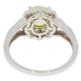 Elegant Green Peridot ring in 14K white gold setting, featuring a sparkling diamond accent, viewed from the side.